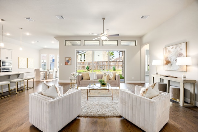 living room featuring plenty of natural light, dark wood finished floors, and visible vents