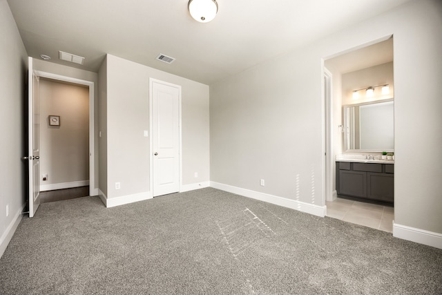 unfurnished bedroom with light carpet, visible vents, and baseboards