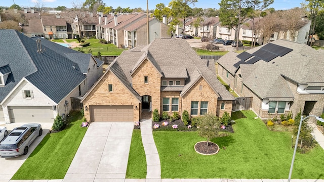 view of front of home with a garage, a shingled roof, concrete driveway, a residential view, and brick siding