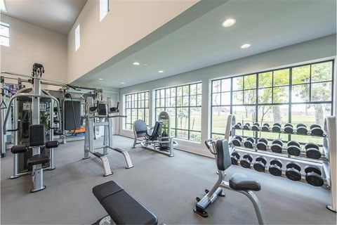 gym featuring recessed lighting and a high ceiling