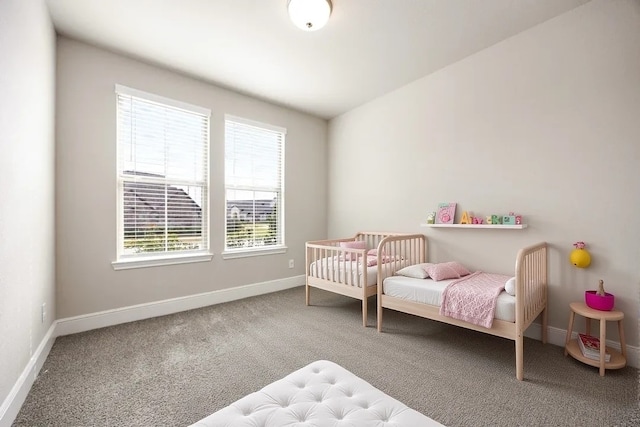 carpeted bedroom with baseboards