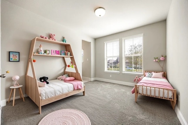 bedroom with carpet floors and baseboards