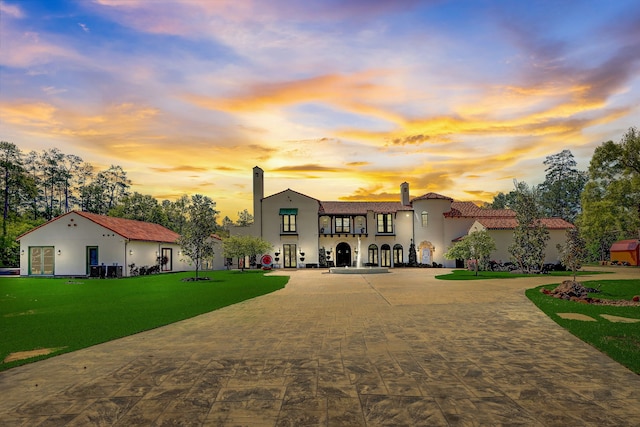 back house at dusk with a yard