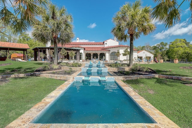 back of property with a gazebo and a yard