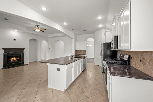 114 Kohen Ct, Montgomery, TX 77316 - kitchen with appliances with stainless steel finishes, a sink, light tile patterned floors, open floor plan, and recessed lighting