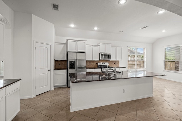114 Kohen Ct, Montgomery, TX 77316 - kitchen featuring appliances with stainless steel finishes, backsplash, a sink, dark stone countertops, and recessed lighting