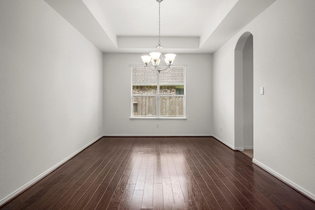 114 Kohen Ct, Montgomery, TX 77316 - spare room with a raised ceiling, a chandelier, wood finished floors, and arched walkways