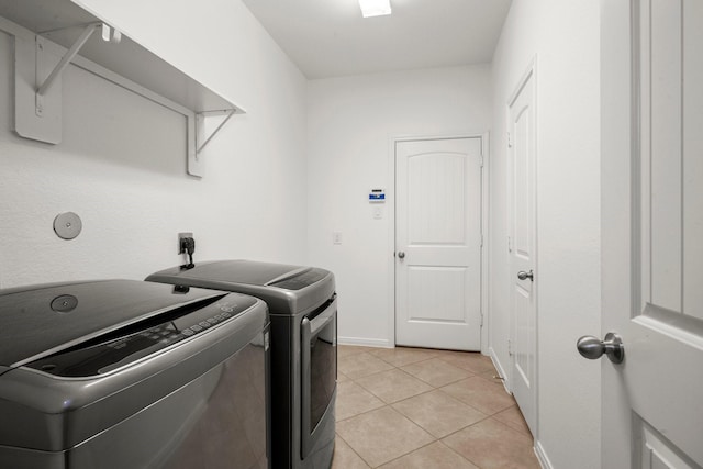 114 Kohen Ct, Montgomery, TX 77316 - washroom featuring washer and clothes dryer, light tile patterned flooring, and baseboards