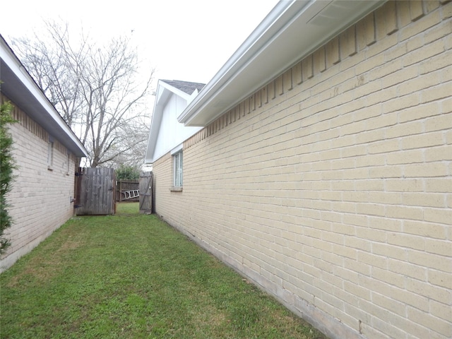 view of side of property with a lawn