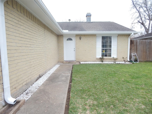 doorway to property featuring a yard