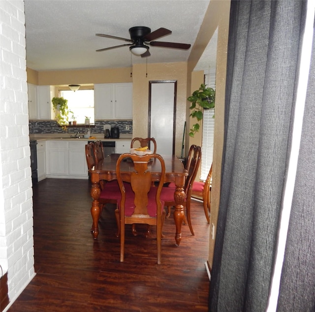 dining space featuring dark hardwood / wood-style floors, a textured ceiling, and ceiling fan