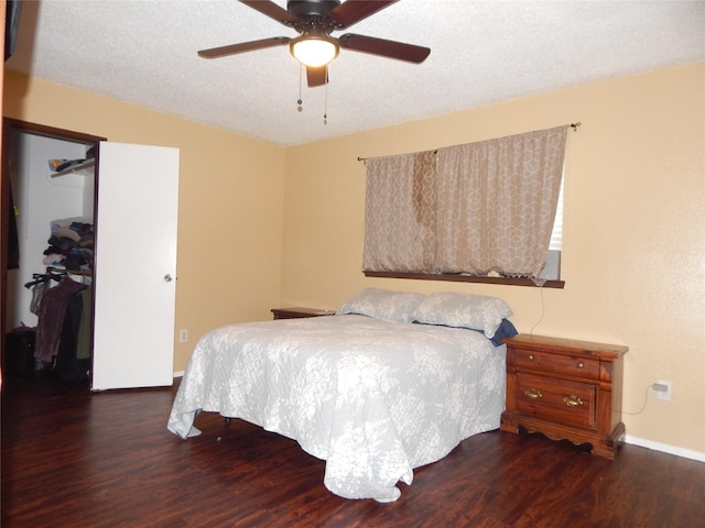 bedroom featuring a textured ceiling, dark hardwood / wood-style flooring, and a closet