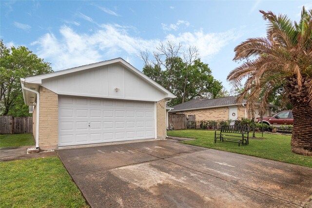 garage with driveway and fence