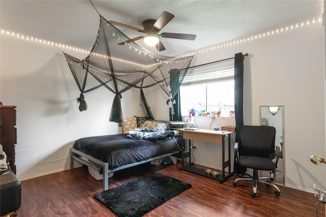 bedroom with baseboards, a ceiling fan, wood finished floors, and a textured ceiling