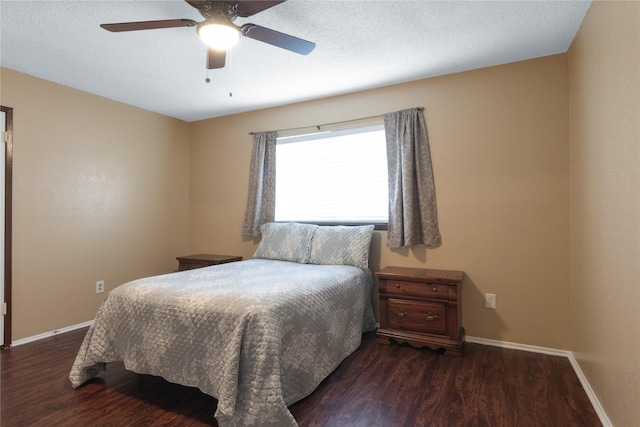 bedroom featuring baseboards, a textured ceiling, and wood finished floors
