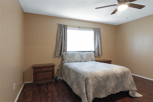 bedroom with a textured ceiling, baseboards, wood finished floors, and a ceiling fan