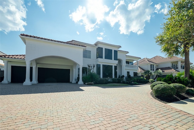 mediterranean / spanish-style house with a garage