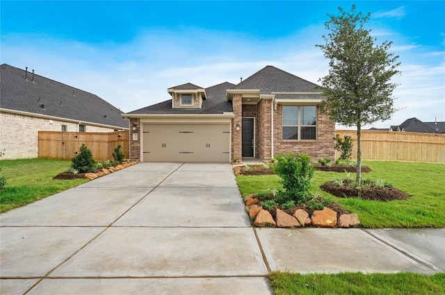 view of front of property with a garage and a front yard