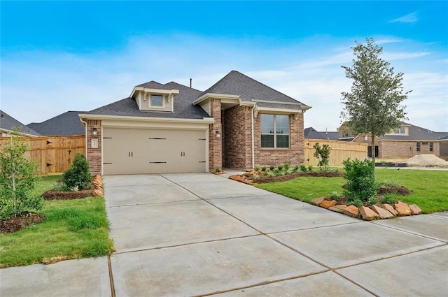 view of front facade featuring a garage and a front lawn