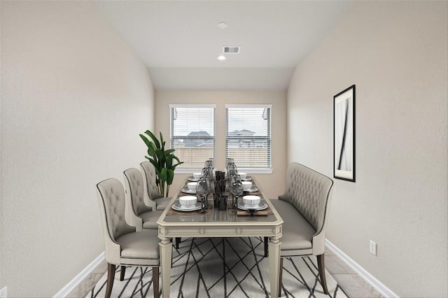 dining room with vaulted ceiling