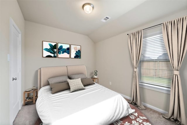 carpeted bedroom with vaulted ceiling