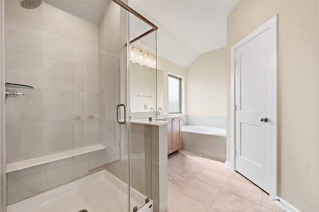 bathroom with vanity, vaulted ceiling, tile patterned floors, and separate shower and tub