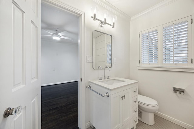 bathroom with crown molding, ceiling fan, vanity, wood-type flooring, and toilet