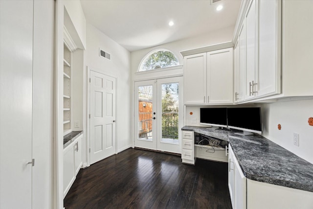 kitchen featuring dark hardwood / wood-style flooring, built in desk, french doors, and white cabinets