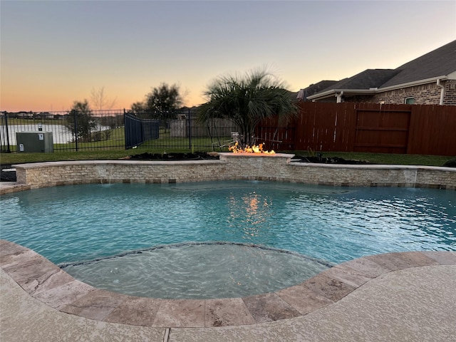 pool at dusk with pool water feature