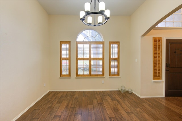 interior space featuring dark wood-type flooring and a chandelier