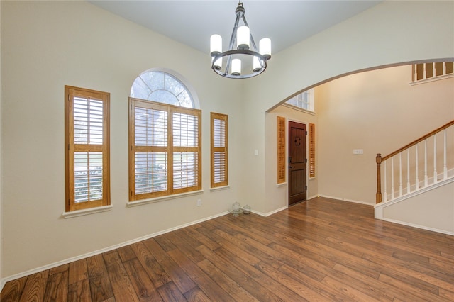 interior space featuring dark hardwood / wood-style floors and a notable chandelier