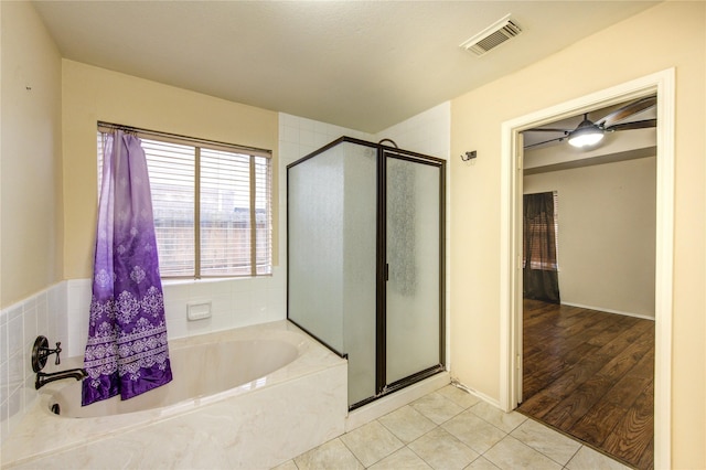 bathroom featuring shower with separate bathtub and tile patterned flooring