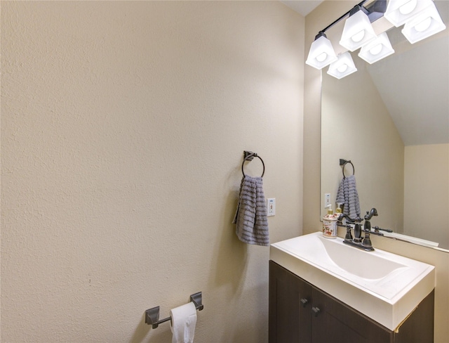 bathroom featuring vanity and vaulted ceiling