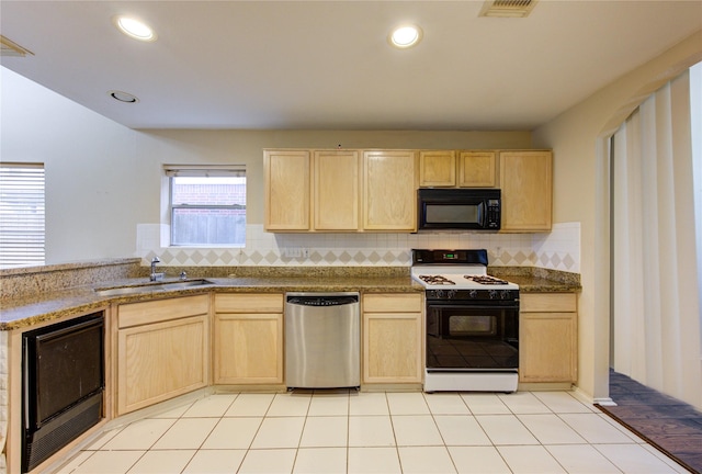 kitchen with sink, gas range, stainless steel dishwasher, and light brown cabinets