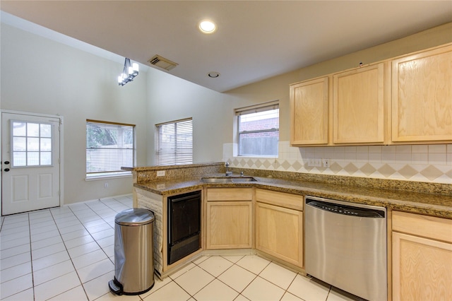 kitchen with dishwasher, sink, light brown cabinets, and light tile patterned floors