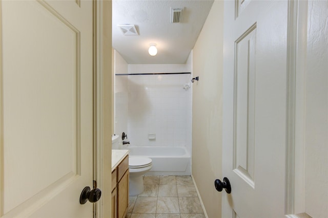 full bathroom featuring vanity, tiled shower / bath, toilet, and a textured ceiling