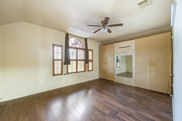 unfurnished bedroom featuring vaulted ceiling, ceiling fan, and dark hardwood / wood-style flooring