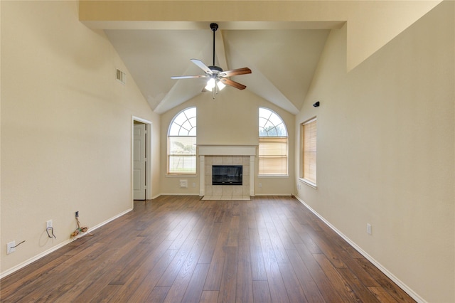 unfurnished living room featuring ceiling fan, high vaulted ceiling, dark wood-type flooring, and a fireplace