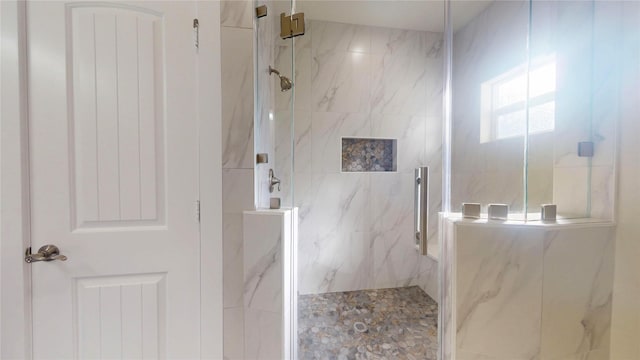 full bath with a marble finish shower