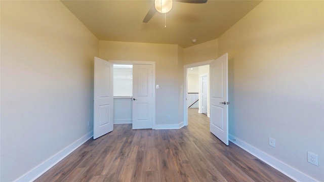 unfurnished bedroom featuring dark wood-style floors, ceiling fan, and baseboards