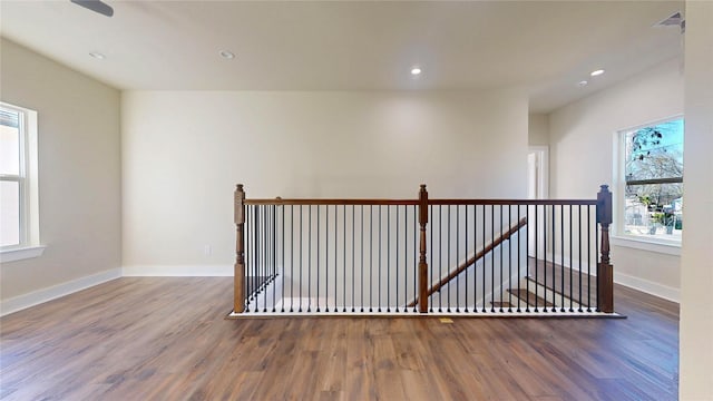 unfurnished room featuring recessed lighting, baseboards, and wood finished floors