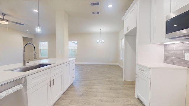 kitchen featuring light countertops, appliances with stainless steel finishes, and a sink