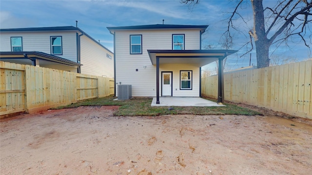 back of property featuring a patio, cooling unit, and a fenced backyard