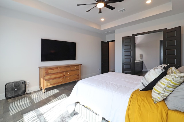 bedroom featuring a tray ceiling, visible vents, and recessed lighting