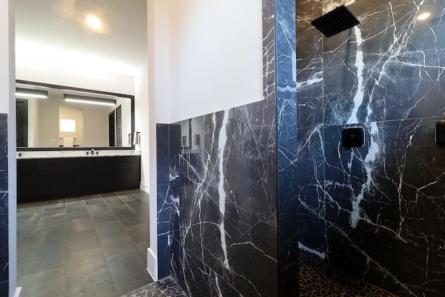 full bathroom featuring vanity and a marble finish shower