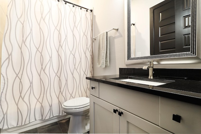 bathroom featuring toilet and vanity