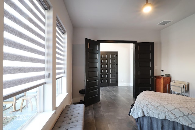 bedroom featuring multiple windows and visible vents