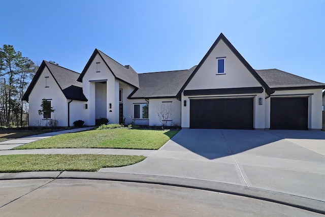 view of front facade with a front yard, an attached garage, stucco siding, and concrete driveway
