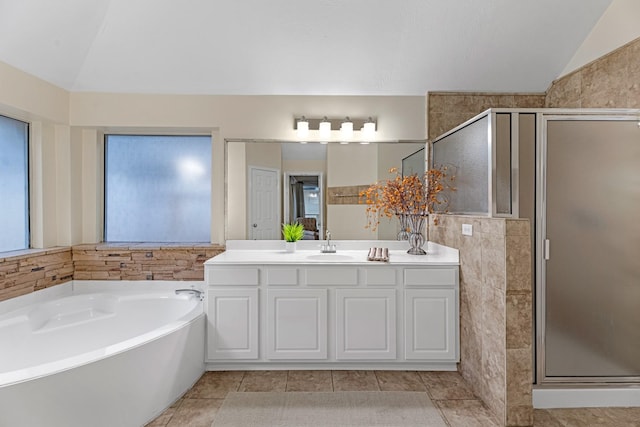 full bathroom with lofted ceiling, tile patterned flooring, a garden tub, vanity, and a shower stall