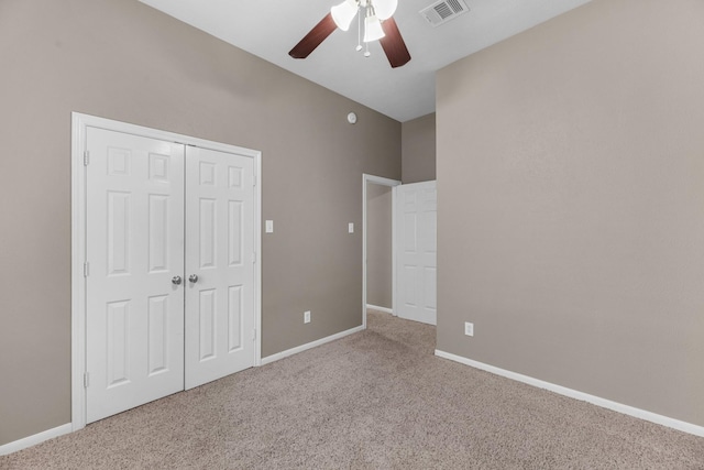 unfurnished bedroom featuring ceiling fan, carpet flooring, visible vents, baseboards, and a closet